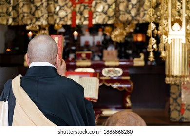 Japanese Monk Praying At A Temple