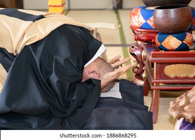 Japanese Monk Praying At A Temple