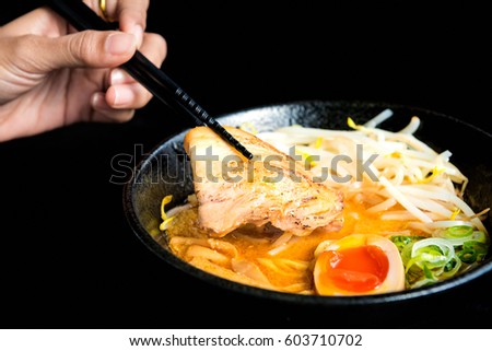 Japanese noodles soup with chicken, egg , chives and sprout on dark background , Woman Eating Tasty Noodle Restaurant Concept , Spicy noodle in Japanese food