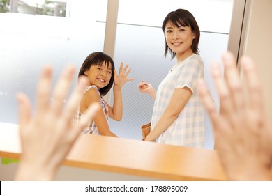 Japanese Parent And Child About To Leave The Dentist