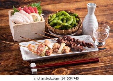 Japanese Popular Izakaya Food And Sake, Edamame, Sashimi, Yakitori 