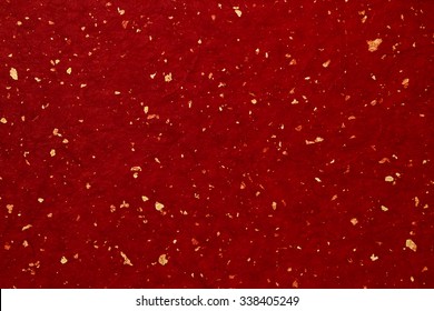 Japanese red paper with gold thread. New Year card background texture.
