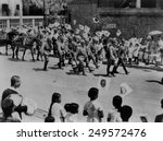Japanese residents of Beijing, China, welcome Japanese invaders. Men, Women and children wave flags and shout 