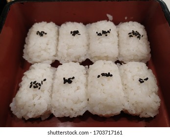 Japanese Rice Balls With Black Sesame Sprinkled On Top In Square Wooden Bento Box.