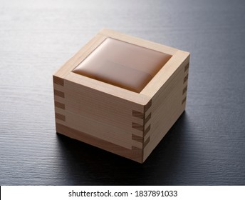 A Japanese Sake Box With A Black Background