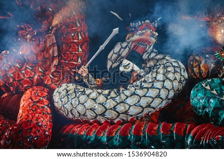 A Japanese samurai fighting against Yamata no Orochi (legendary 8-headed and 8-tailed Japanese dragon) in Kagura performance