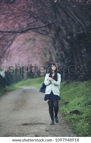 Similar – beautiful young woman smiling while walking in the park