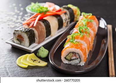 Japanese seafood sushi set on stone table, close-up.