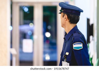 Japanese Security Guard From Back At Tokyo By Night