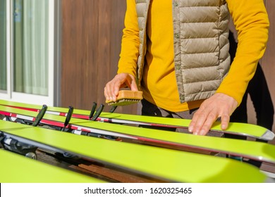 Japanese Senior Woman Waxing Skis