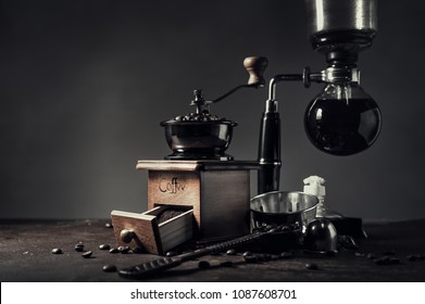 Japanese siphon coffee maker and coffee grinder on old kitchen table background, It is very fragrant and aroma because filled with fresh coffee beans. - Powered by Shutterstock