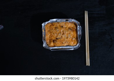 A Japanese Snack In The Form Of Mayonnaise Dumplings Baked In An Aluminum Foil Box And Served With A Pair Of Chopsticks To Eat It 