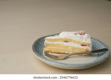 Japanese strawberry shortcake and fork on each stylish large and small plate on a wooden table. - Powered by Shutterstock