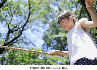 Japanese student girl playing with rope walking (7 years old) - Powered by Shutterstock