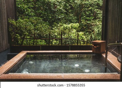 Japanese style onsen hot spring with calming nature view - Shutterstock ID 1578855355