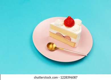 Japanese Style Strawberry Shortcake On The Pink Plate On White Background. Side View. Copy Space For Your Text.