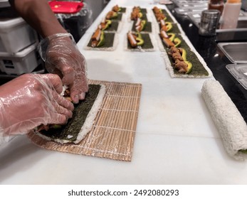 Japanese sushi chef prepare many Sushi, portioned prepared vinegared rice topped or rolled with other ingredients Japanese dish on kitchen countertop. - Powered by Shutterstock