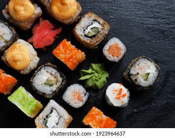 Japanese sushi food. Maki ands rolls with tuna, salmon, shrimp, crab and avocado. Top view of assorted sushi. Rainbow sushi roll, uramaki, hosomaki and nigiri.