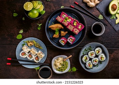 japanese sushi food. Maki ands rolls with tuna, salmon, shrimp, crab and avocado. Top view of assorted sushi. Rainbow sushi roll, uramaki, hosomaki and nigiri.  - Shutterstock ID 2151226323