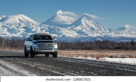 Japanese SUV Toyota Tundra Driving Along Road On Background Of Kamchatka Winter Landscape - Kluchevskaya Group Of Volcanoes On Clear Sunny Day. Kamchatka Peninsula, Russian Far East - January 7, 2016.