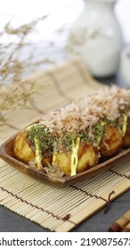 Japanese Takoyaki With Bonito Flakes And Nori Powder Snack On Wood Wooden Plate