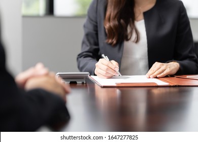 A Japanese tax accountant hearing about your insurance and inheritance concerns - Shutterstock ID 1647277825