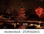 Japanese Temple (Det Japanske Tårn) lit up at night during Halloween at Tivoli Amusement Park, Copenhagen, Denmark.