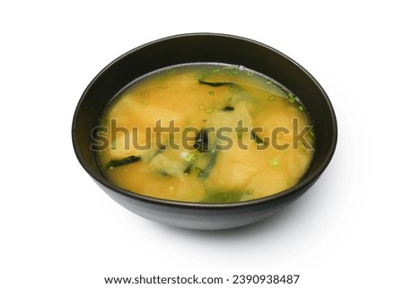 Japanese tofu soup or Miso Soup. A soup is a staple in Japanese cuisine. Miso soup with tofu and Wakame seaweed in brown Japanese bowl isolated on white background