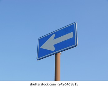 A Japanese traffic sign.
A blue background with white arrow indicates that this road is a one-way street. - Powered by Shutterstock