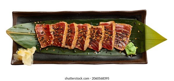 Japanese Tuna Sashimi Tataki On Green Leaf. Isolated Over White Background