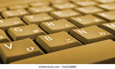 Japanese Typing. Dark Yellow Laptop Keyboard Closeup. Symbols On Buttons Of Hiragana. Light Brown Tinted Computer Wallpaper Or Background. Electronic Commerce In Japan. IT Technology And Data Storage