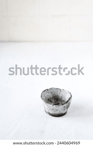 Japanese whiskey, SAKE, tea in a small ceramic cup on a white background with a place for text. Japanese style. Wabi-sabi.