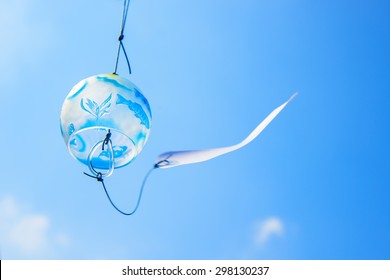 Japanese Wind Chime Against Blue Sky