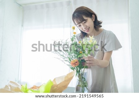 Japanese woman arranging flowers at home