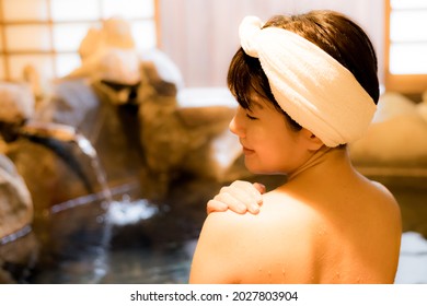 Japanese Woman Bathing In Hot Spring Made Of Rock