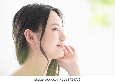 Japanese woman with a beautiful smile and hands on her face, easy to use for beauty Copy space