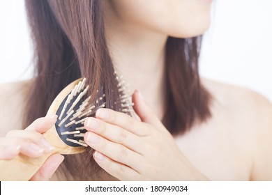 Japanese Woman Combing Her Hair With A Brush