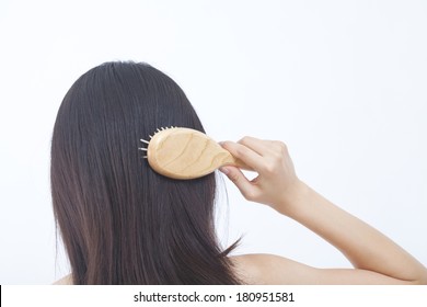 Japanese Woman Combing Her Hair With A Brush,