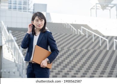 

Japanese woman in a dark blue suit - Shutterstock ID 1900562587