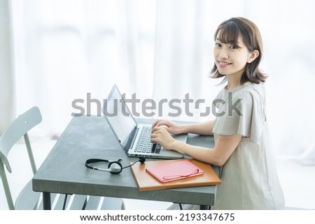 
Japanese woman doing desk work at home