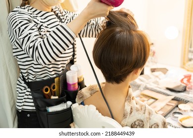 Japanese Woman Doing Hair And Makeup