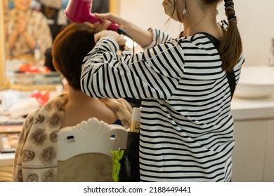 Japanese Woman Doing Hair And Makeup