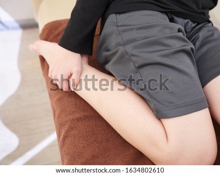 Japanese woman doing self massage / stretch