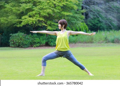 Japanese Woman Doing Yoga Warrior II Pose