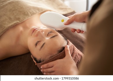 Japanese Woman Getting A Photo Facial At An Aesthetic Salon