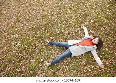 Japanese Woman Laying Down On Leaves