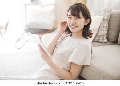 Japanese Woman Operating A Tablet Device