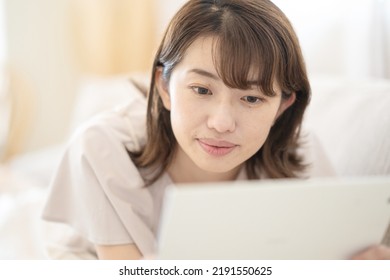 Japanese Woman Operating A Tablet Device