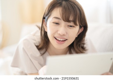 Japanese Woman Operating A Tablet Device