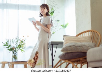 Japanese Woman Operating A Tablet Device